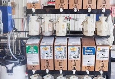 Fluid services | Little Wolf Automotive | Waupaca, WI, image of boxes of fluid stacked on top of each other is shop