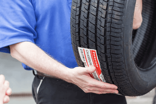 4 Reasons why Tire Service is Especially Important in the Winter Months with Little Wolf Automotive in Waupaca, WI; closeup image of LW owner Scott holding tire to show client
