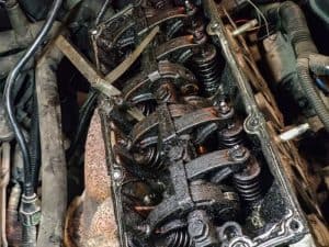 What Happens If You Skip an Oil Change? | Little Wolf Automotive Express Lube in Plover, WI. Image of dirty valves and engine camshaft inside a car engine.