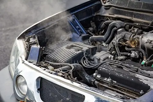 4 Tips for a Cooler Car This Summer | Little Wolf Automotove in Waupaca, WI. Image of overrated car engine. Concept image of cooling system repair and maintenance, including radiator and car AC.