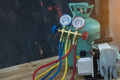 Manometers, refrigerant tank, and vacuum pump measuring equipment for filling air conditioners. Concept image of “The New R1234yf Refrigerant for Car AC System: What You Need to Know” | Little Wolf in Waupaca, WI.