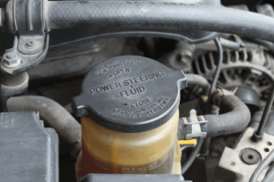 Can you mix different power steering fluids in Antigo and Waupaca, WI with Little Wolf Automotive and Express Lube. Image of power steering fluid reservoir on a car.