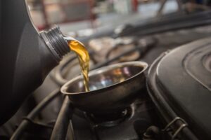 a pouring oil into a car Express Lube, Oil Change In Rothschild WI At Eagle Express Lube