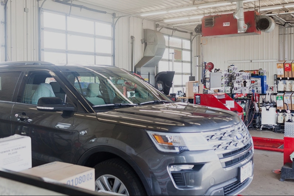 Fall Auto Maintenance In Waupaca WI At Little Wolf Automotive. Vehicle inside an auto repair shop for maintenance service