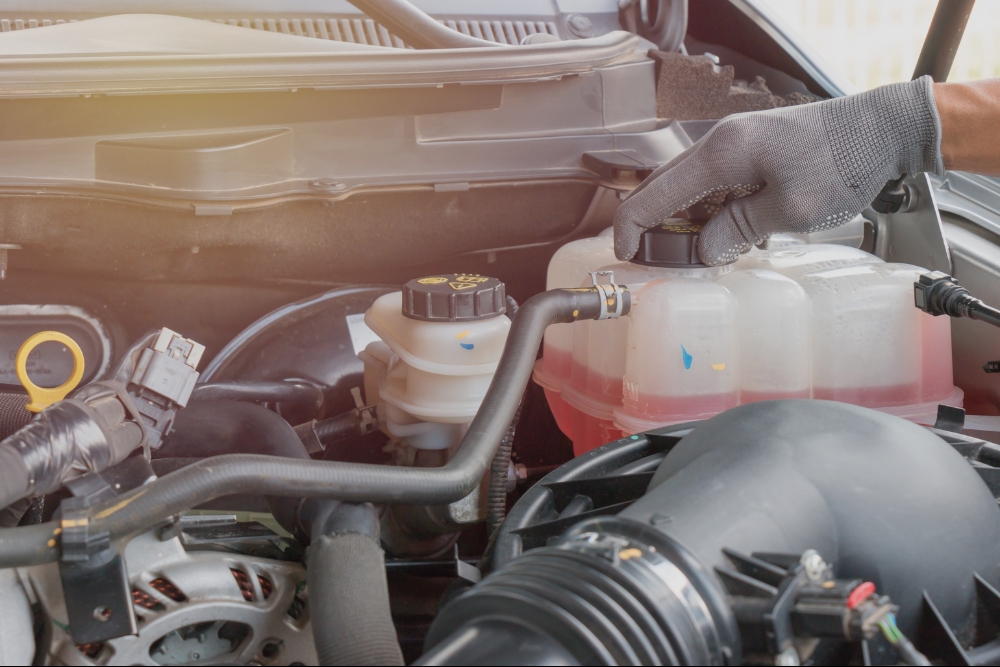 Fall & Winter Car Prep, Fluid & Lube Services in Rothschild, WI At Eagle Express Lube. Mechanic checking engine fluid during vehicle maintenance service