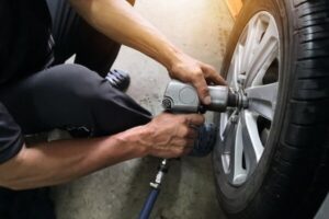 Fall Tire Services In Antigo WI At Little Wolf Automotive. Auto mechanic performing tire services inside an auto repair shop