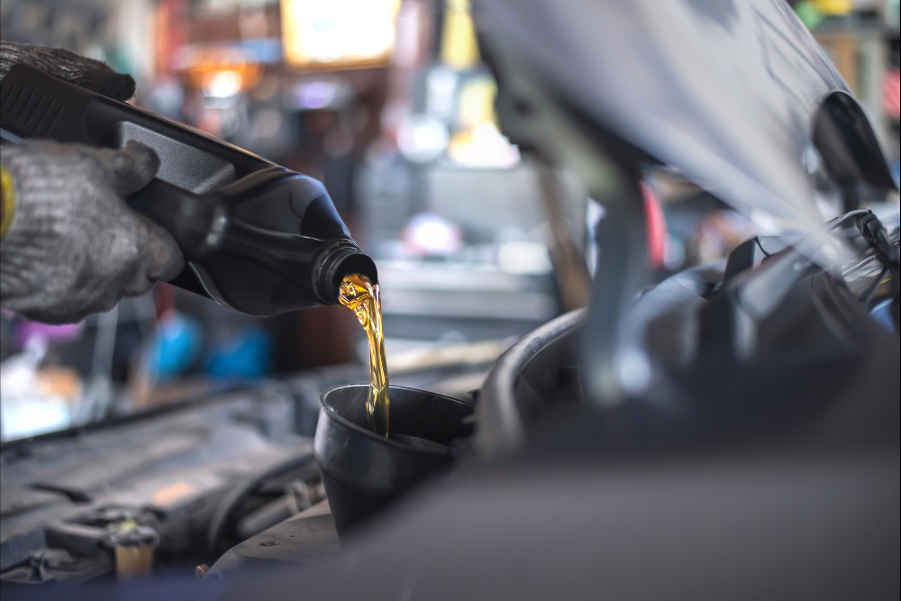 Winter car maintenance in Antigo, WI by Little Wolf Automotive Express Lube. Close-up of oil change and battery service preparing a vehicle for cold weather.