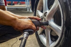 Tire Rotation and Balance in Antigo WI At Little Wolf Automotive. Close-up view of tire being rotated
