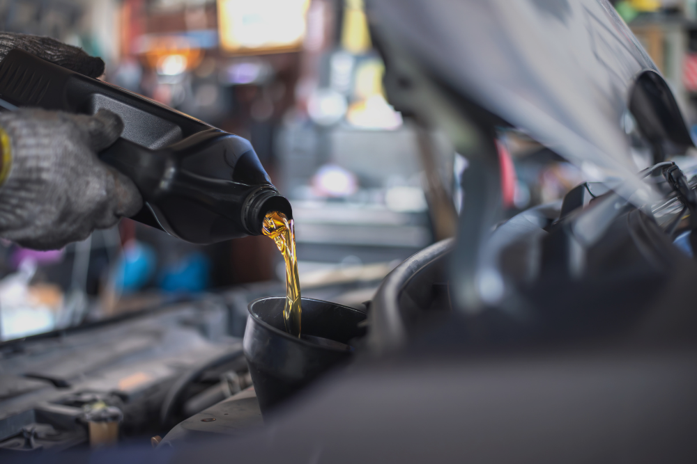 Oil Change in Antigo, WI At Little Wolf Automotive Express Lube. Image of oil being poured into a car engine