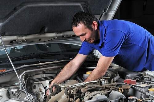 Fast Vehicle Maintenance with Quality Parts and Service by Little Wolf in Antigo, WI. Image of a car mechanic working on a car.