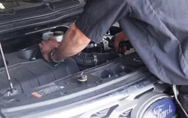 Image of mechanic fixing a car engine. Concept image of diesel engine repair in Little Wolf Auto.