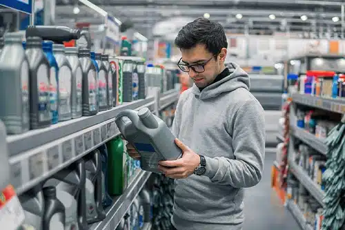 Is 5W30 or 10W30 Better for Winter? | Little Wolf Automotive in Antigo, WI. Image of a male customer buying engine oil in the car supermarket.