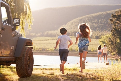 Excited family reaching countryside destination on road trip. Concept image of “5 Best Things to Do In & Near Antigo, WI” | Little Wolf Auto in Antigo, WI.