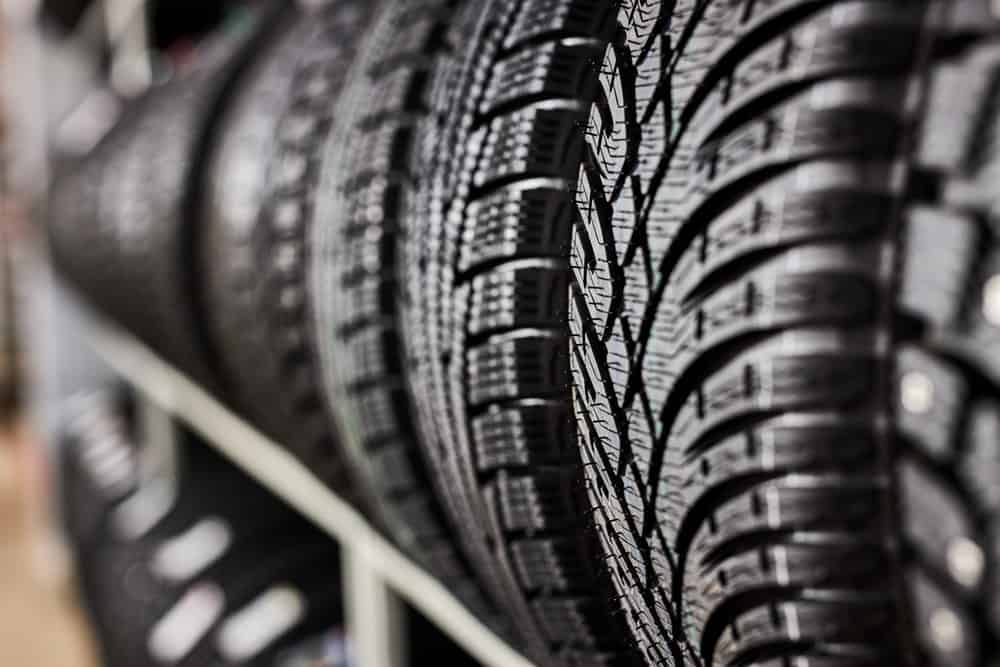 Find the right tires for your car in Antigo, WI at Little Wolf Express Lube. Close up image of new tires on rack at shop.