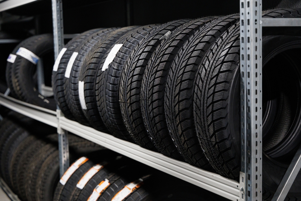 Best Tires at Little Wolf Automotive: Shelves filled with various new car tires, representing the range of options available, emphasizing the importance of choosing between cheap and big brand tires for cost-effectiveness and safety.