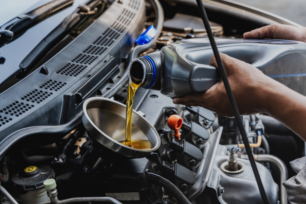 Oil Change, Winter Auto Maintenance in Rothschild, WI At Eagle Express Lube. Mechanic performing an engine oil change