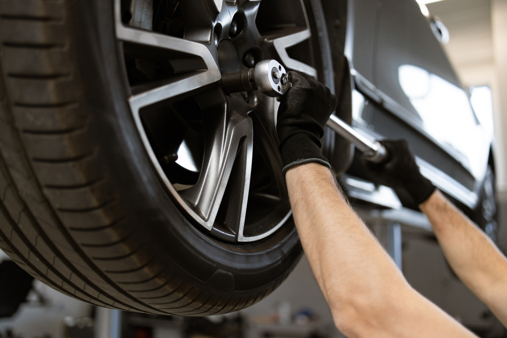 Tire Repair or Tire Mounting in Antigo WI At Little Wolf Automotive Express Lube. Professional tire service with vehicle elevated for repair