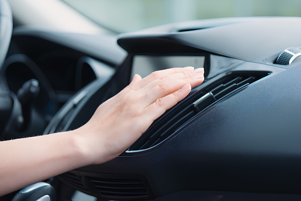 Auto Air Conditioning Repair in Waupaca WI at Little Wolf Automotive. Image of Hand inspecting car air conditioning